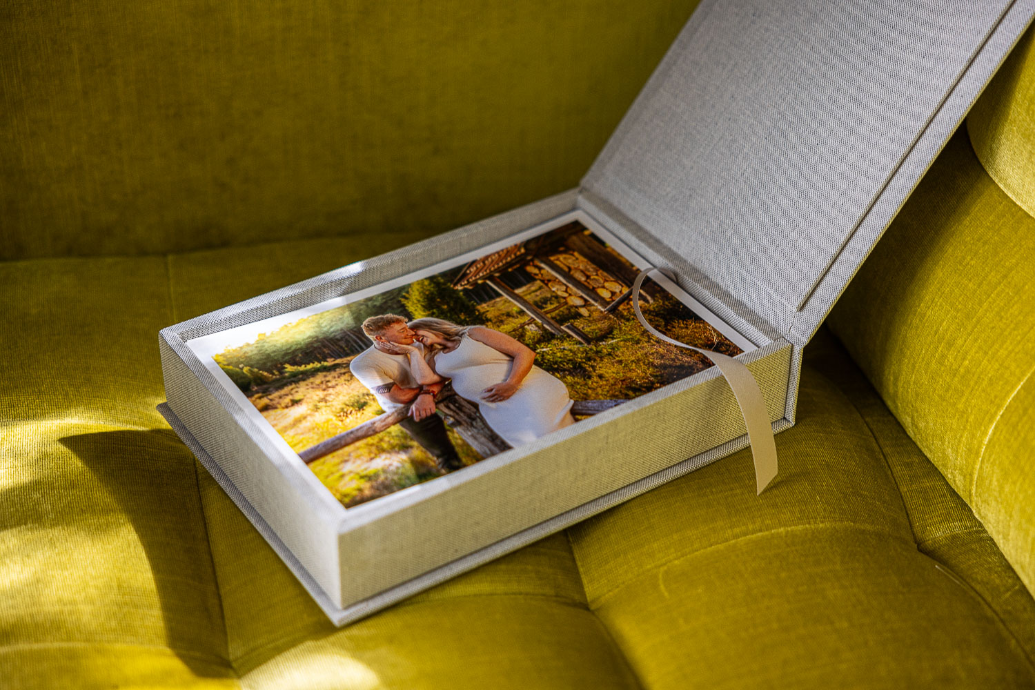 Fotobox mit Fineart Prints auf gelbem Sessel